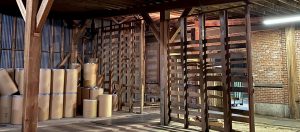 barn-like warehouse with empty shipping barrels at The Master Package Fibre Shipping Containers