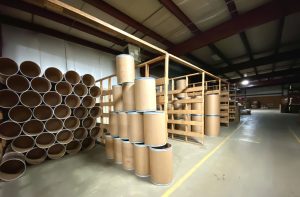 stacked steel bands on fibre barrels in orderly fashion at warehouse at The Master Package Fibre Shipping Containers